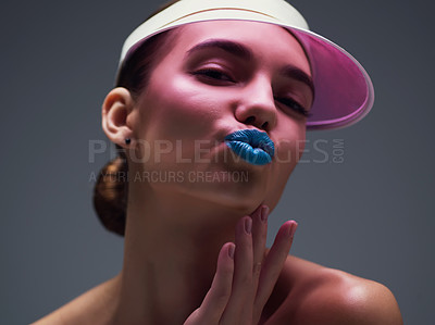 Buy stock photo Studio shot of an attractive young woman wearing a pink retro cap posing against a gray background