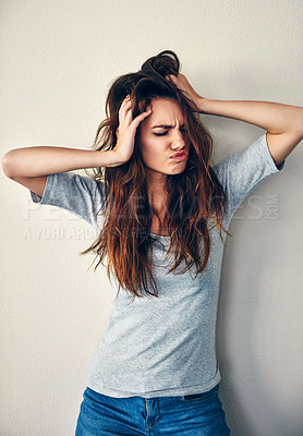 Buy stock photo Studio shot of an attractive young woman posing with her hands in her hair