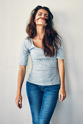 Buy stock photo Studio shot of an attractive young woman posing against a grey background