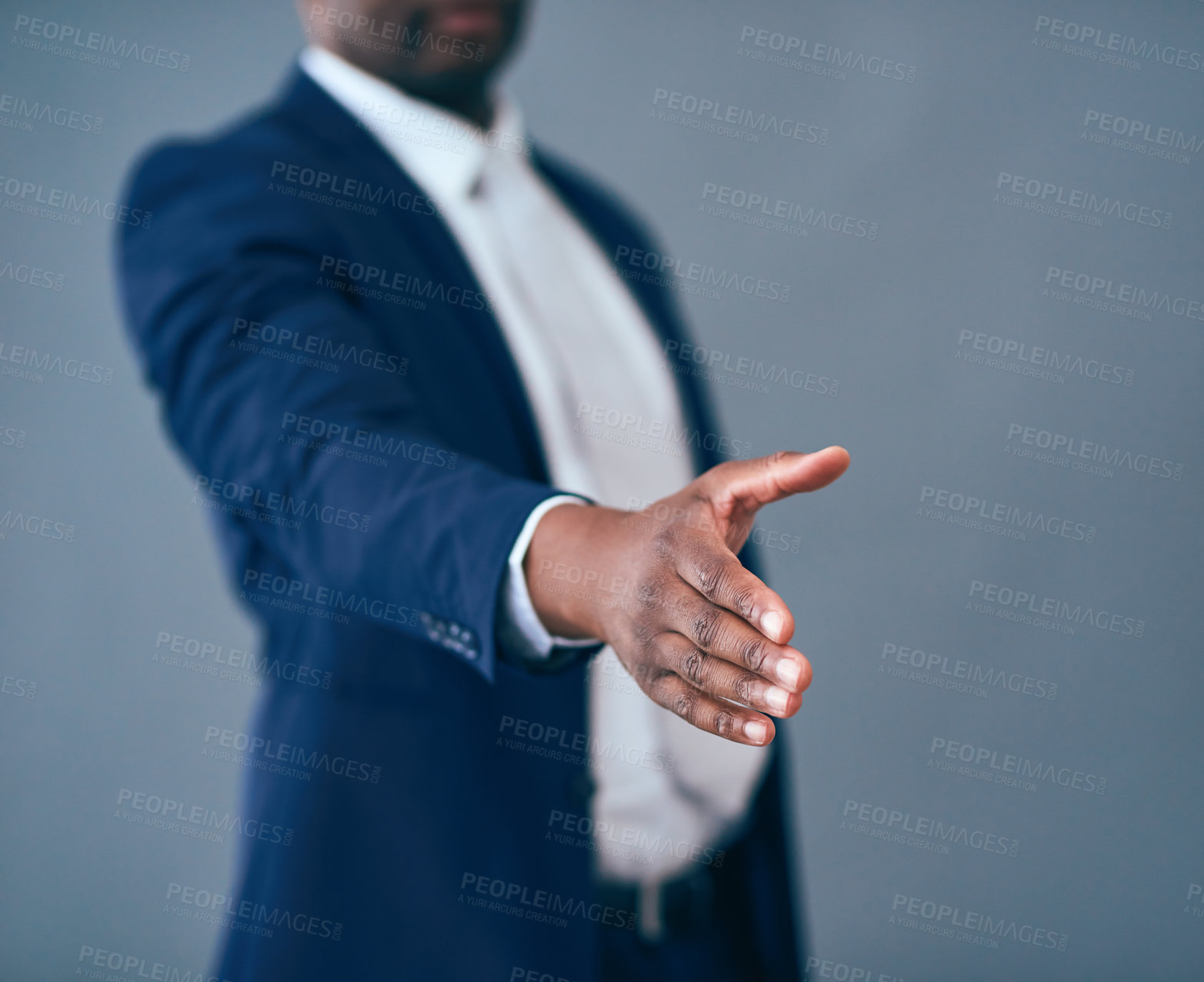 Buy stock photo Studio shot of an unrecognizable corporate businessman putting his hand out for a handshake against a gray background