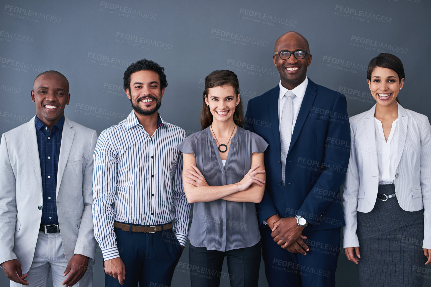 Buy stock photo Studio shot of  corporate businesspeople posing against a gray background