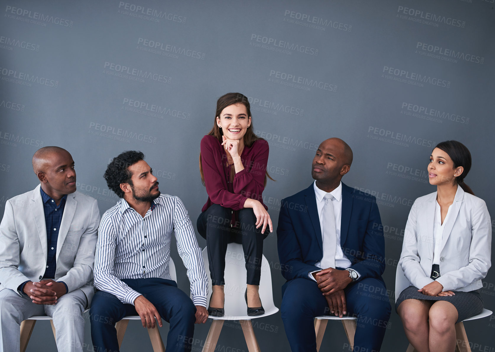 Buy stock photo Studio shot of a group of corporate businesspeople waiting in line against a gray background