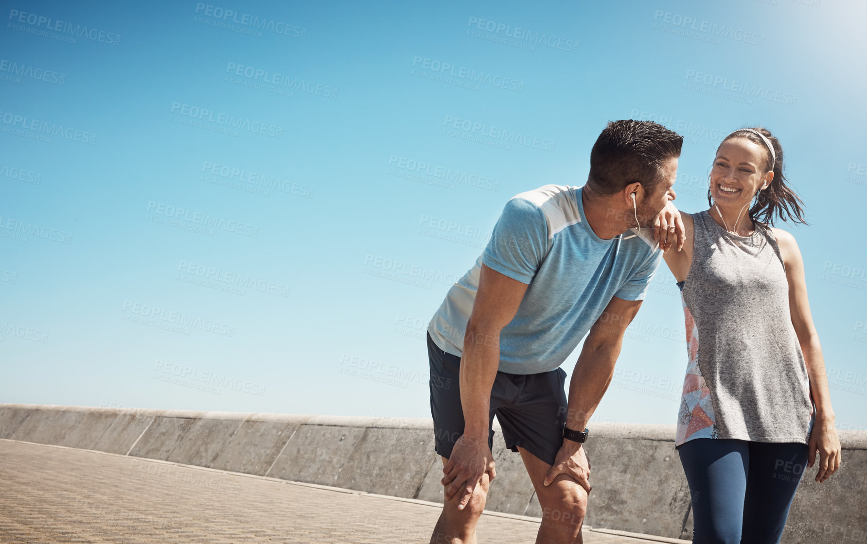 Buy stock photo Cropped shot of a young couple out for a run on the promenade