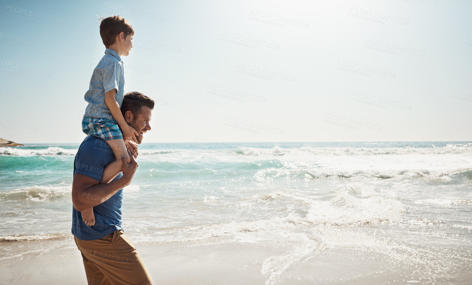 Buy stock photo Dad, beach and boy child on shoulders for walk, vacation and sunshine to relax with care, love or bonding. Man, father and son with piggy back, connection and outdoor by waves, ocean and mockup space