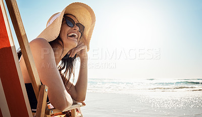 Buy stock photo Beach, summer and mockup with a woman laughing while sitting on a chair by the ocean or sea on vacation. Blue sky, view and horizon over water with an attractive young female tourist feeling happy