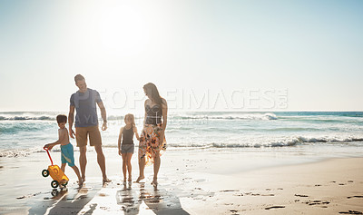 Buy stock photo Shot of a family of four spending the day at the beach