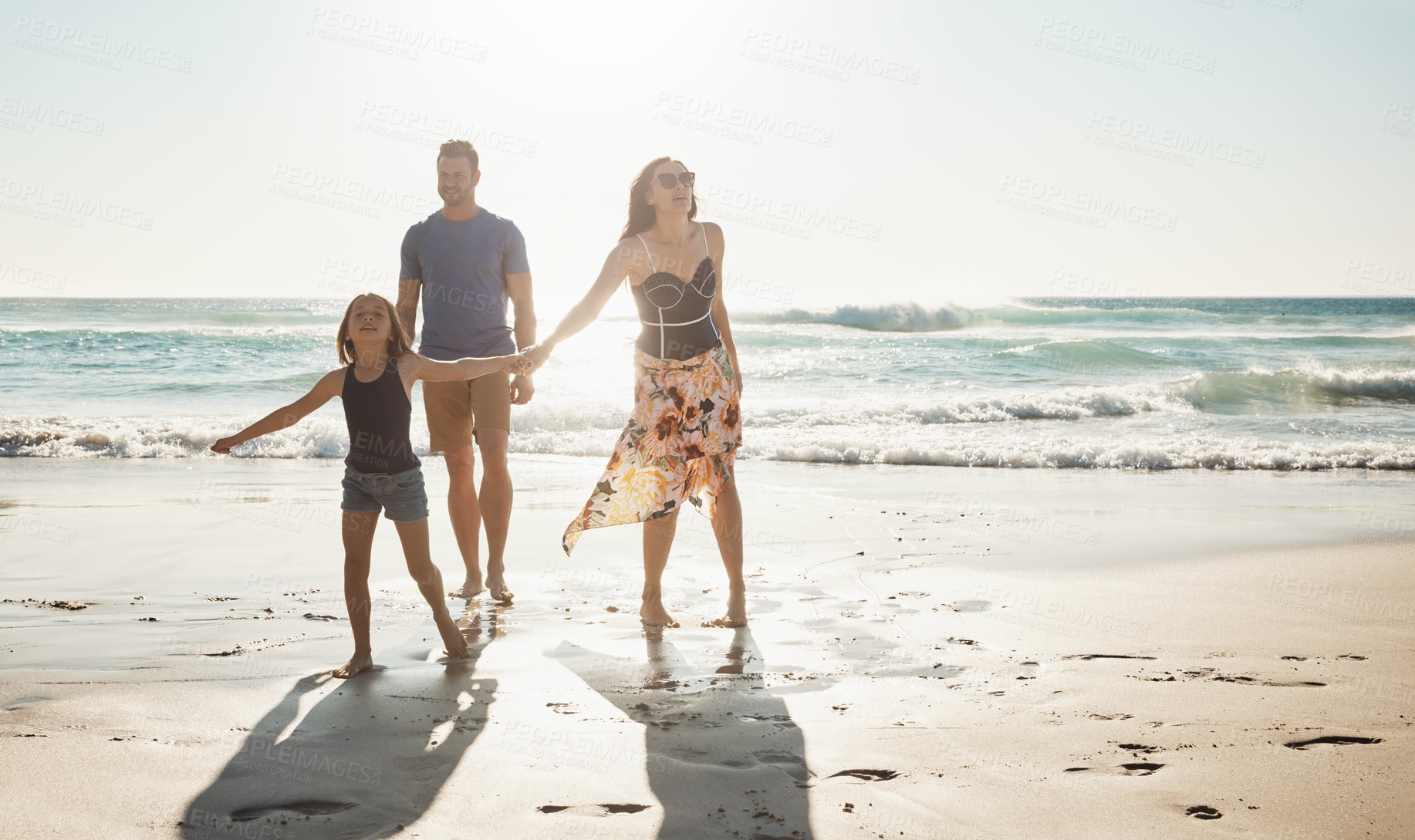 Buy stock photo Shot of a couple at the beach with their young daughter