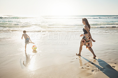 Buy stock photo Shot of a young woman spending the day at the beach with her son