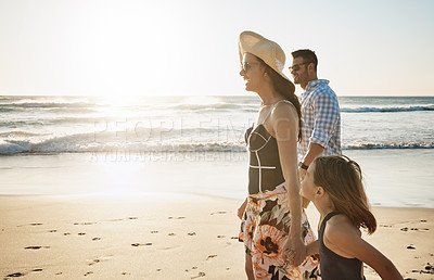 Buy stock photo Shot of a couple at the beach with their young daughter