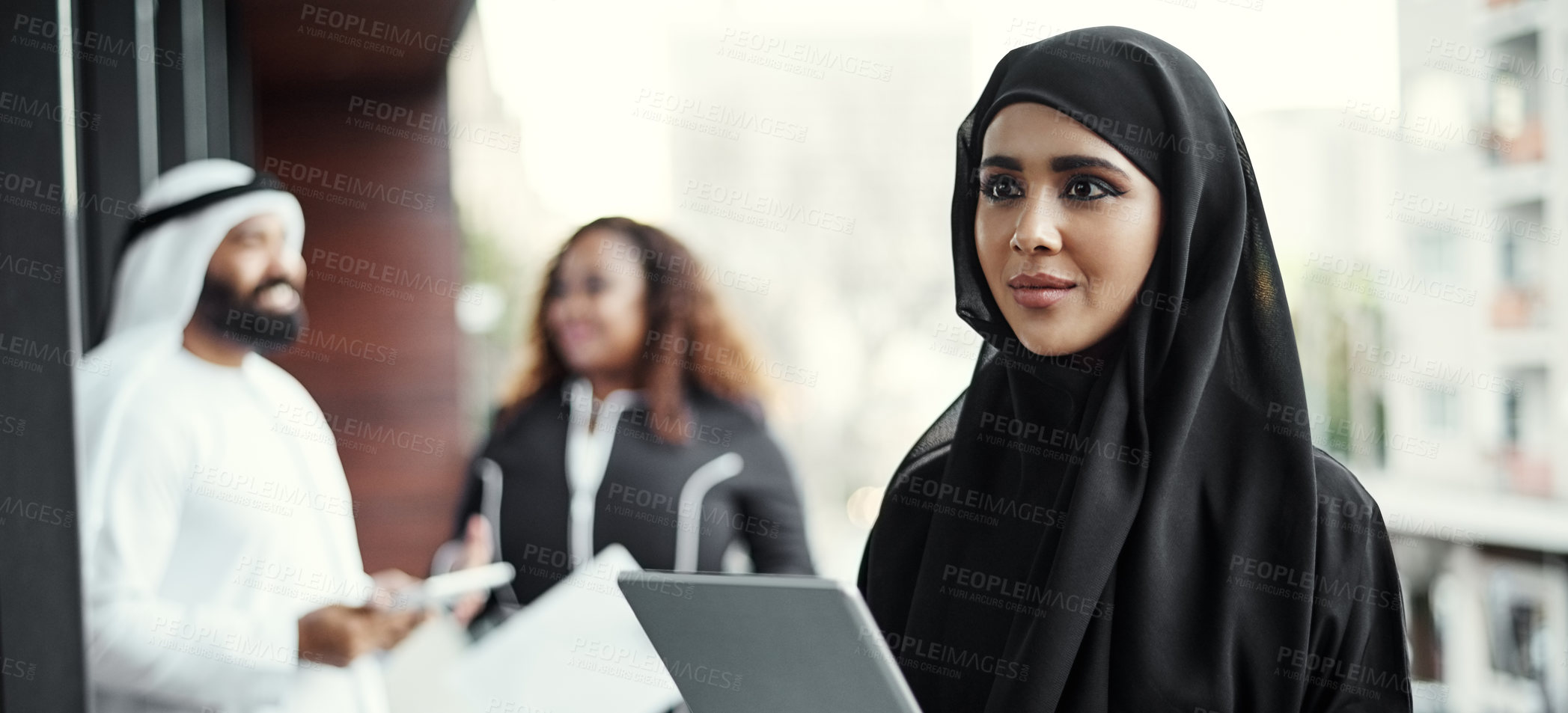 Buy stock photo Cropped shot of an attractive young businesswoman dressed in Islamic traditional clothing using a tablet on her office balcony