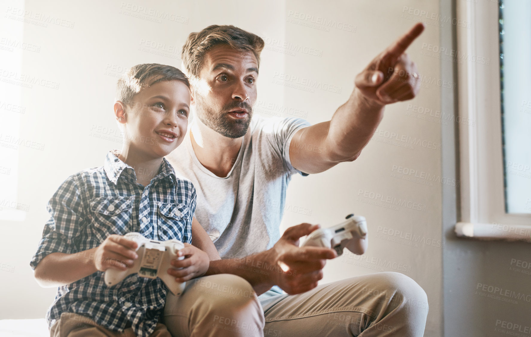 Buy stock photo Father, son and playing with controller for video games, entertainment or bonding together at home. Dad and happy child, young kid or little boy with smile for console, holiday or leisure at house