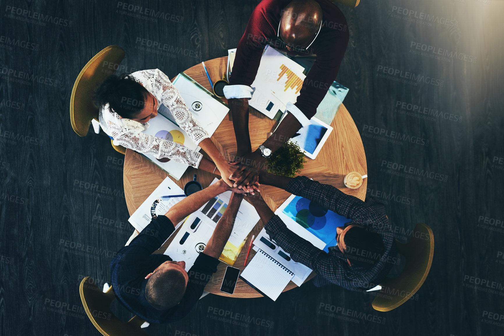 Buy stock photo Above, business people and hands stack at meeting, circle or support for motivation, teamwork and diversity. Men, women and solidarity in scrum by documents, technology and graphs at creative agency