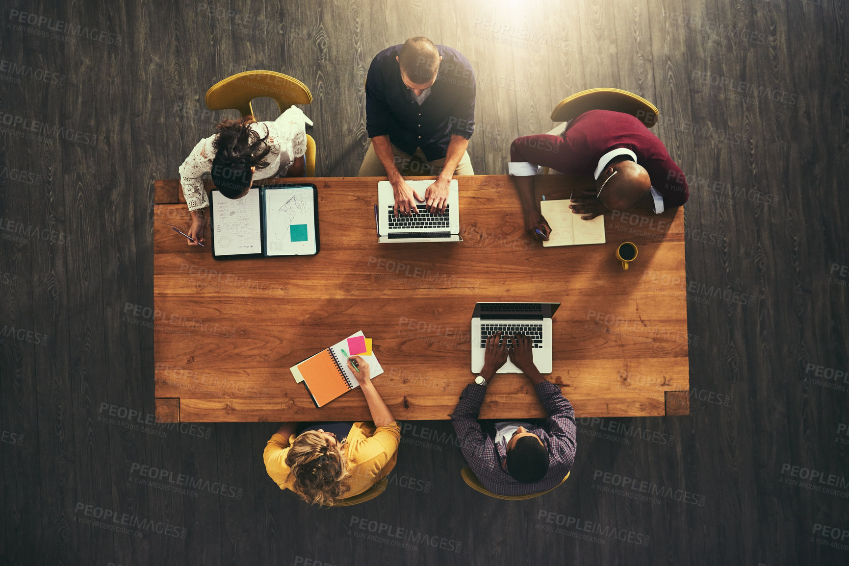 Buy stock photo High angle shot of a group of businesspeople having a meeting in a modern office