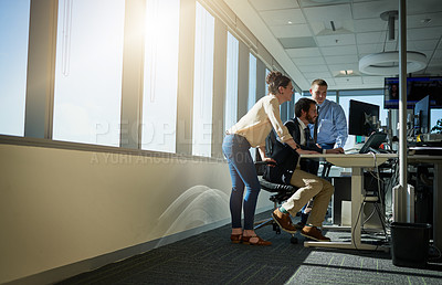 Buy stock photo Full length shot of three young businesspeople working together in their office