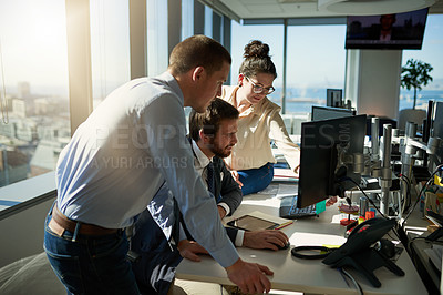 Buy stock photo Full length shot of three young businesspeople working together in their office