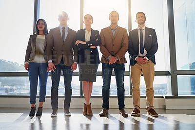 Buy stock photo Full length shot of a group of businesspeople standing in their office