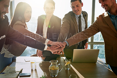 Buy stock photo Cropped shot of a group of businesspeople with their hands in a huddle