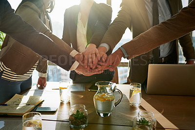 Buy stock photo Cropped shot of a group of unrecognizable businesspeople with their hands in a huddle