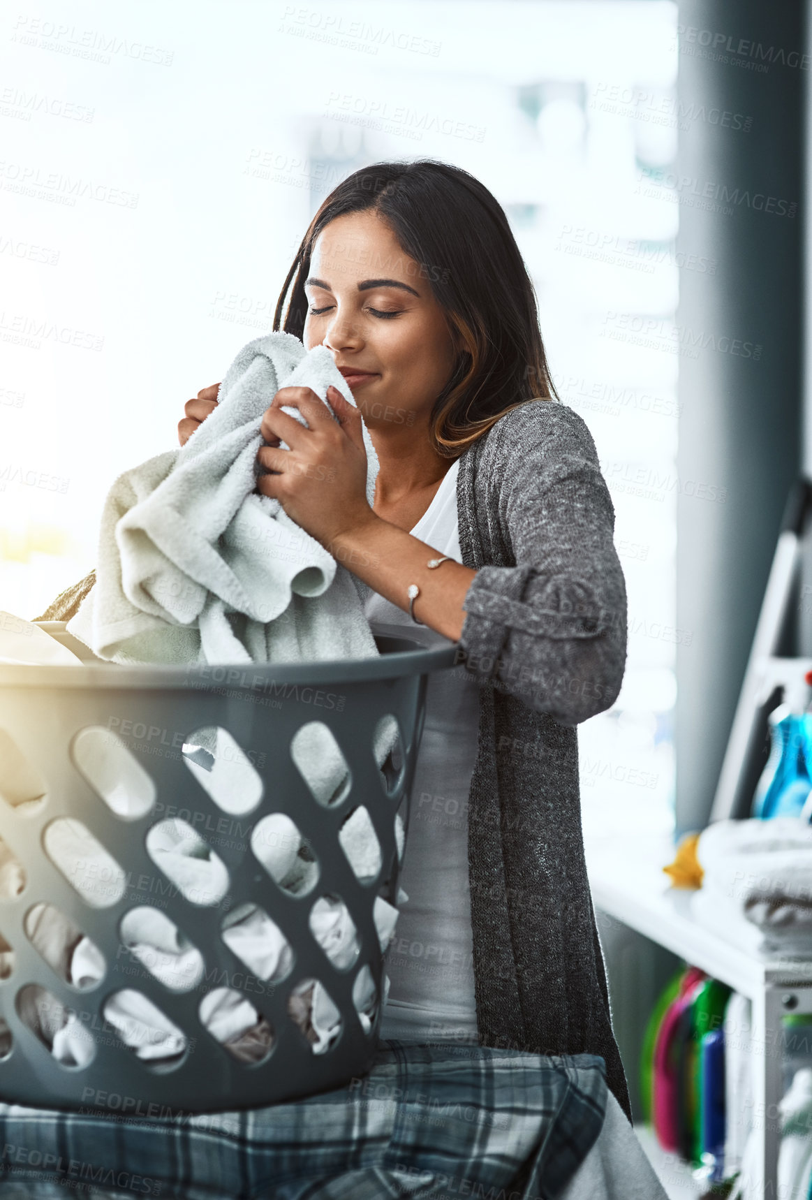 Buy stock photo Woman, laundry scent and basket for clean towel in home, hygiene and fresh linen aroma. Female person, breathe and housework tasks on morning, check blanket and cleaner or maid for fragrance smell