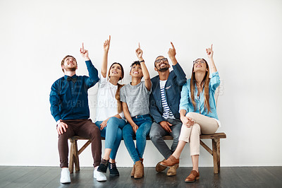 Buy stock photo Creative business people, diversity and group pointing up for wall, mockup and space with opportunity. Employees, teamwork and smile with hand gesture, collaboration and decision for choice approval