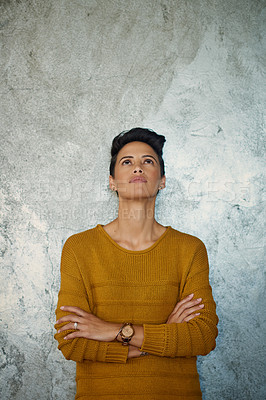 Buy stock photo Shot of a young businesswoman standing against a grey wall