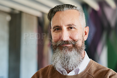 Buy stock photo Portrait of a cheerful middle aged man looking at the camera while standing alone in his office during the day