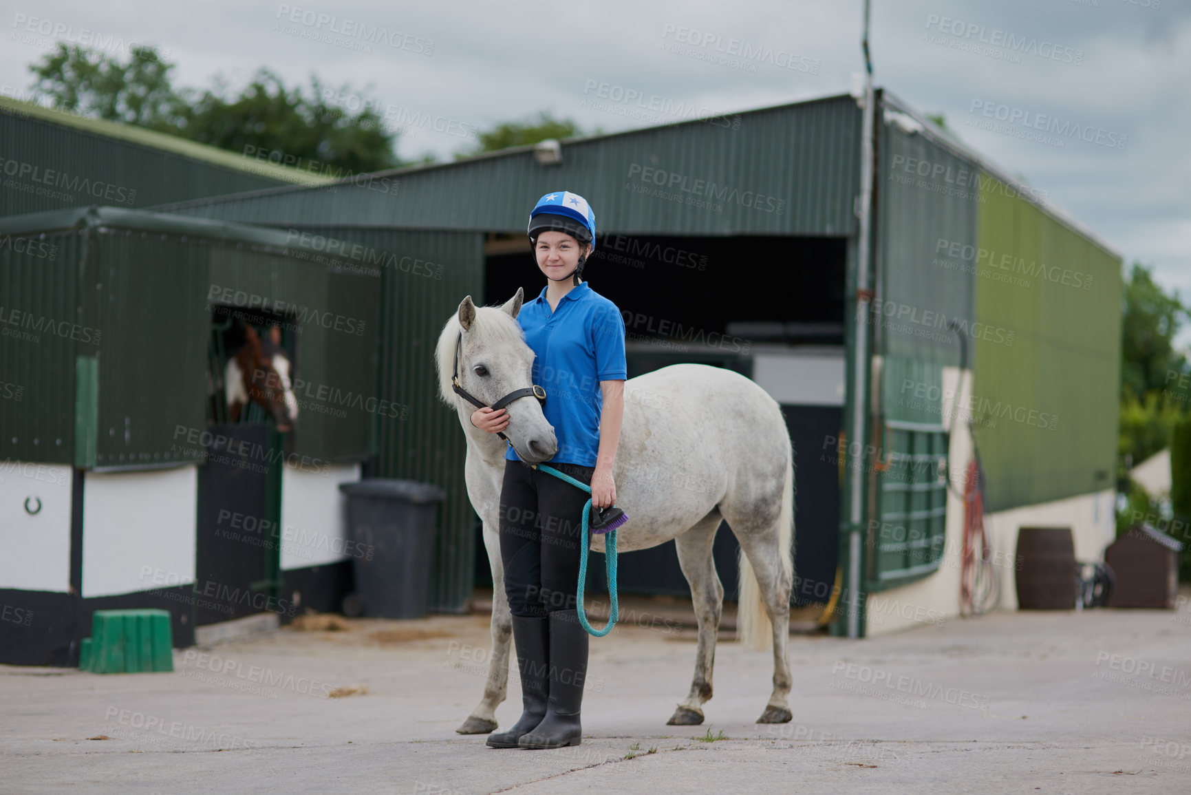 Buy stock photo Girl, horse and portrait outdoor for equestrian, development and learning with bonding or connection. Teenager, animal and pet by stable for riding, care and fitness with smile, exercise and helmet
