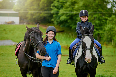 Buy stock photo Shot of young girls and their horses outdoors