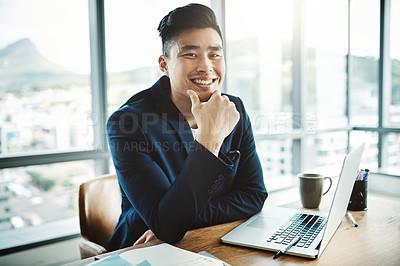 Buy stock photo Portrait of a happy young businessman working at his desk in a modern office