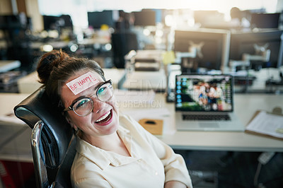 Buy stock photo Shot of a cheerful young businesswoman with a sticky note on her forehead saying 