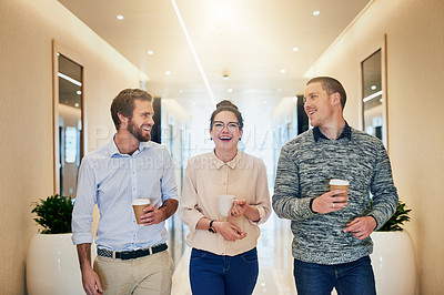 Buy stock photo Portrait of a group of young businesspeople walking together down a passage while drinking coffee