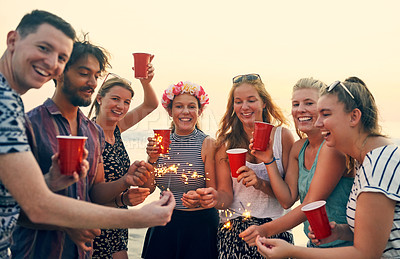 Buy stock photo Shot of young people hanging out at the beach