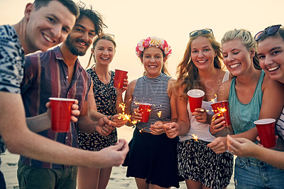 Buy stock photo Group, sparklers and beach with friends portrait at sunset party for summer, vacation or holiday in nature together. New years, drinks and celebration with people, bonding and drinking by Miami sea