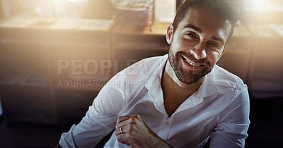 Buy stock photo High angle portrait of a handsome young businessman working late in the office