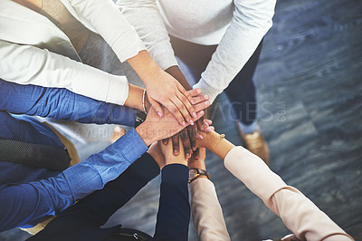 Buy stock photo Cropped shot of a group of businesspeople putting their hands together in a huddle