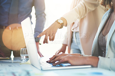 Buy stock photo Cropped shot of unrecognizable businesspeople discussing something on a laptop