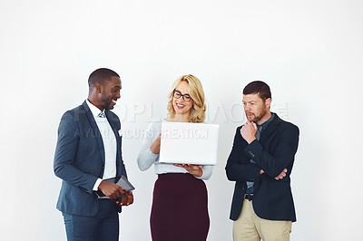 Buy stock photo Studio shot of businesspeople looking at something on a laptop