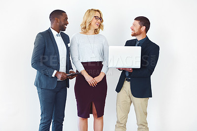 Buy stock photo Studio shot of three businesspeople discussing something on a laptop