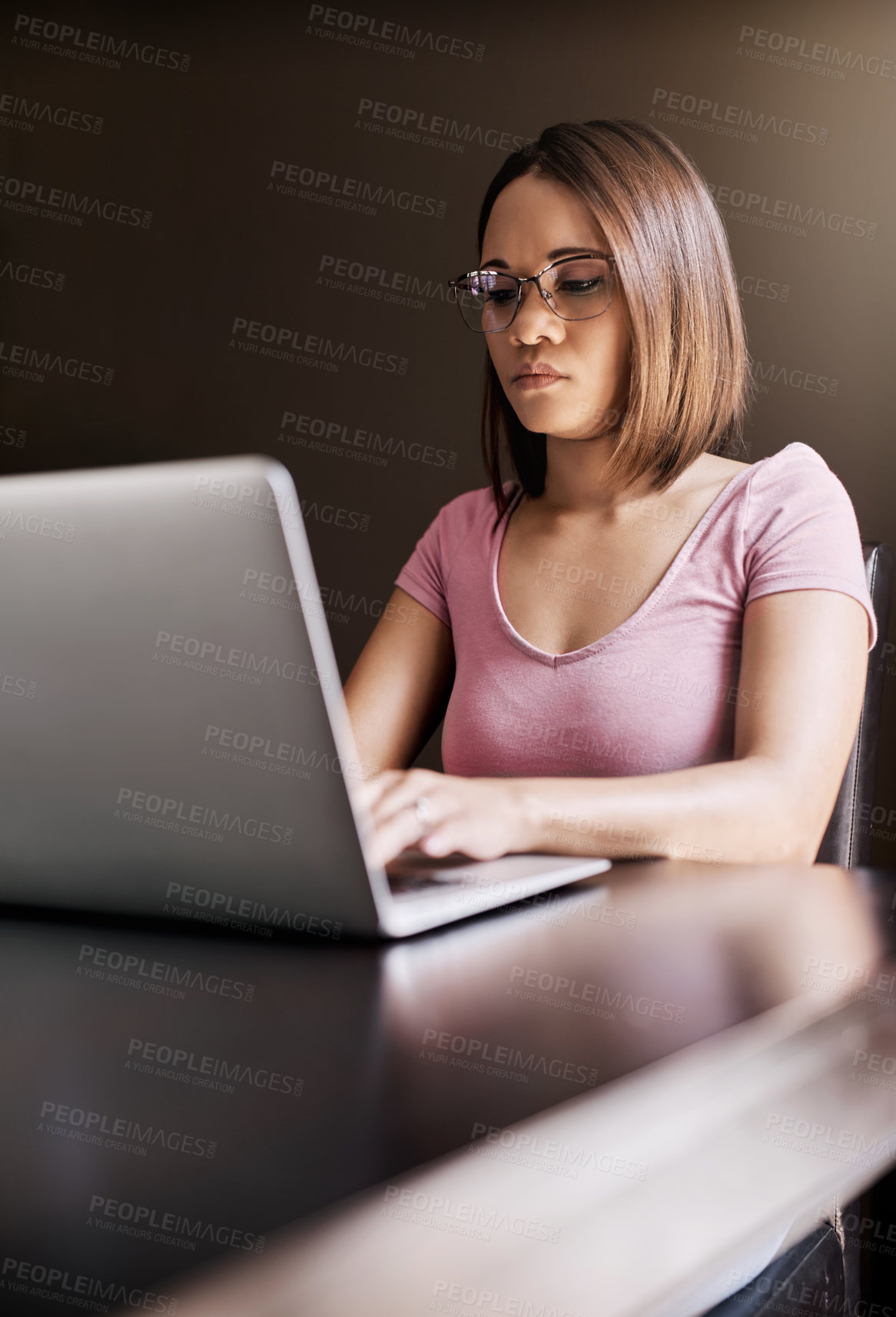 Buy stock photo Cropped shot of an attractive young businesswoman working from home