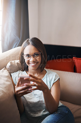 Buy stock photo Cropped shot of an attractive young woman using a cellphone at home