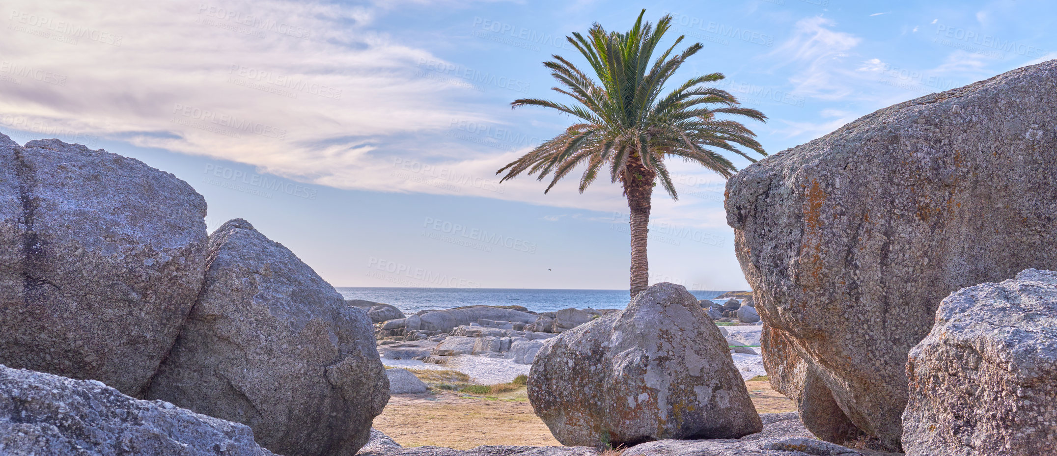 Buy stock photo Rocks, sand and beach coast for freedom, holiday trip and tranquility in tropical island of New Zealand. Boulders, peace and travel to sea waves in nature, ocean vacation and sustainable adventure