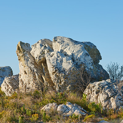 Buy stock photo Landscape, rocks and environment with nature, plants and sunshine with season. Empty, stone and blue sky with leaves, ecology and sustainability with mountain, eco friendly and travel with tourism