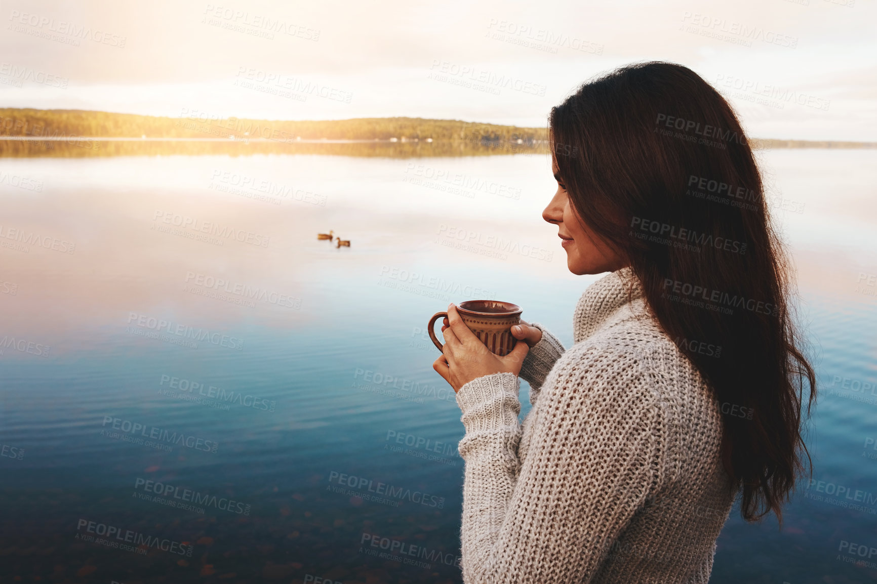 Buy stock photo Nature, smile and woman with coffee in river, sunrise and outdoor with joy in vacation and morning. Break, writer and girl thinking of inspiration in countryside of Finland with peace and lake