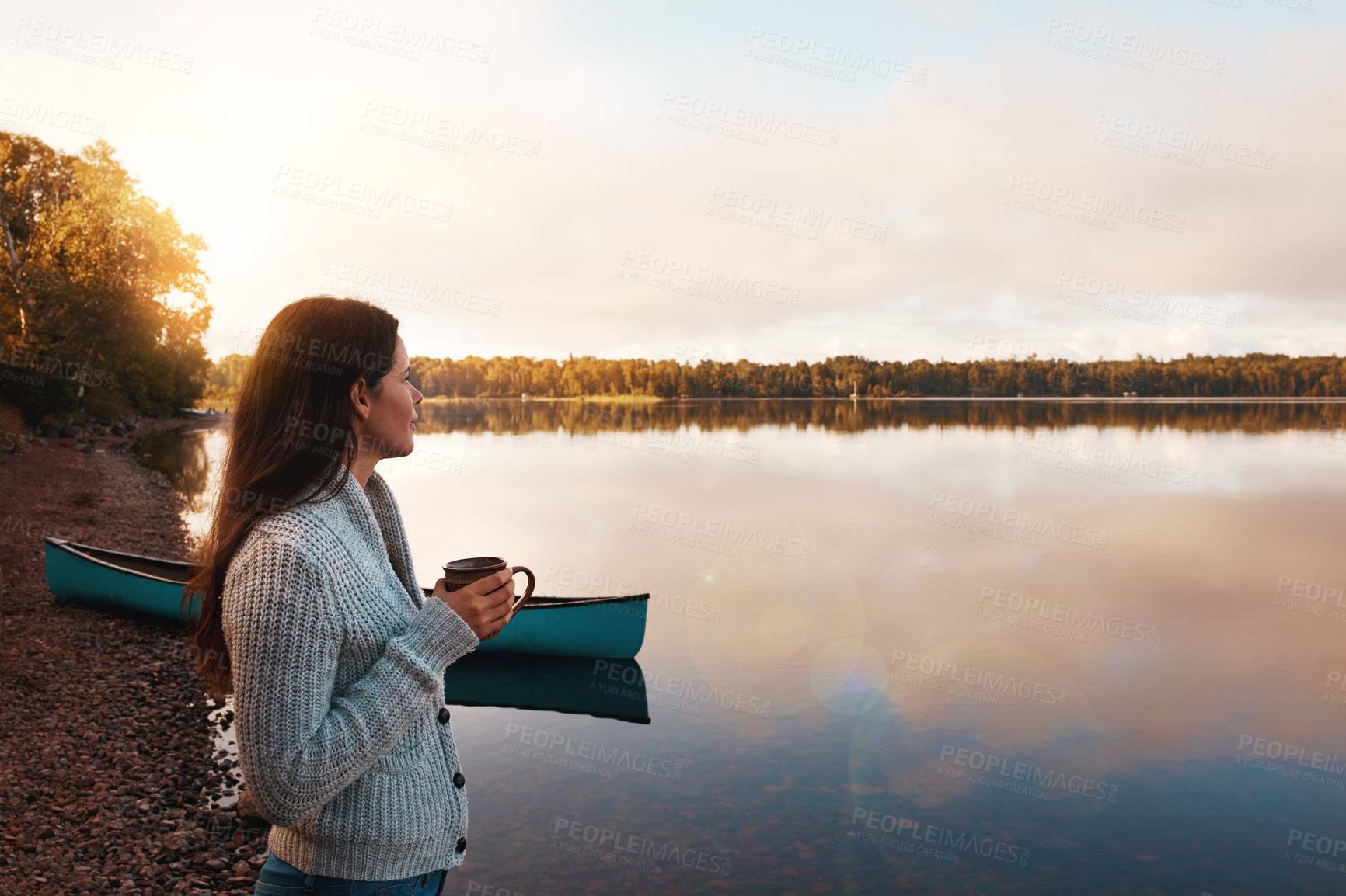 Buy stock photo Cropped shot of an attractive young woman spending time alone by the lake