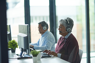 Buy stock photo Shot of call centre agents working in an office