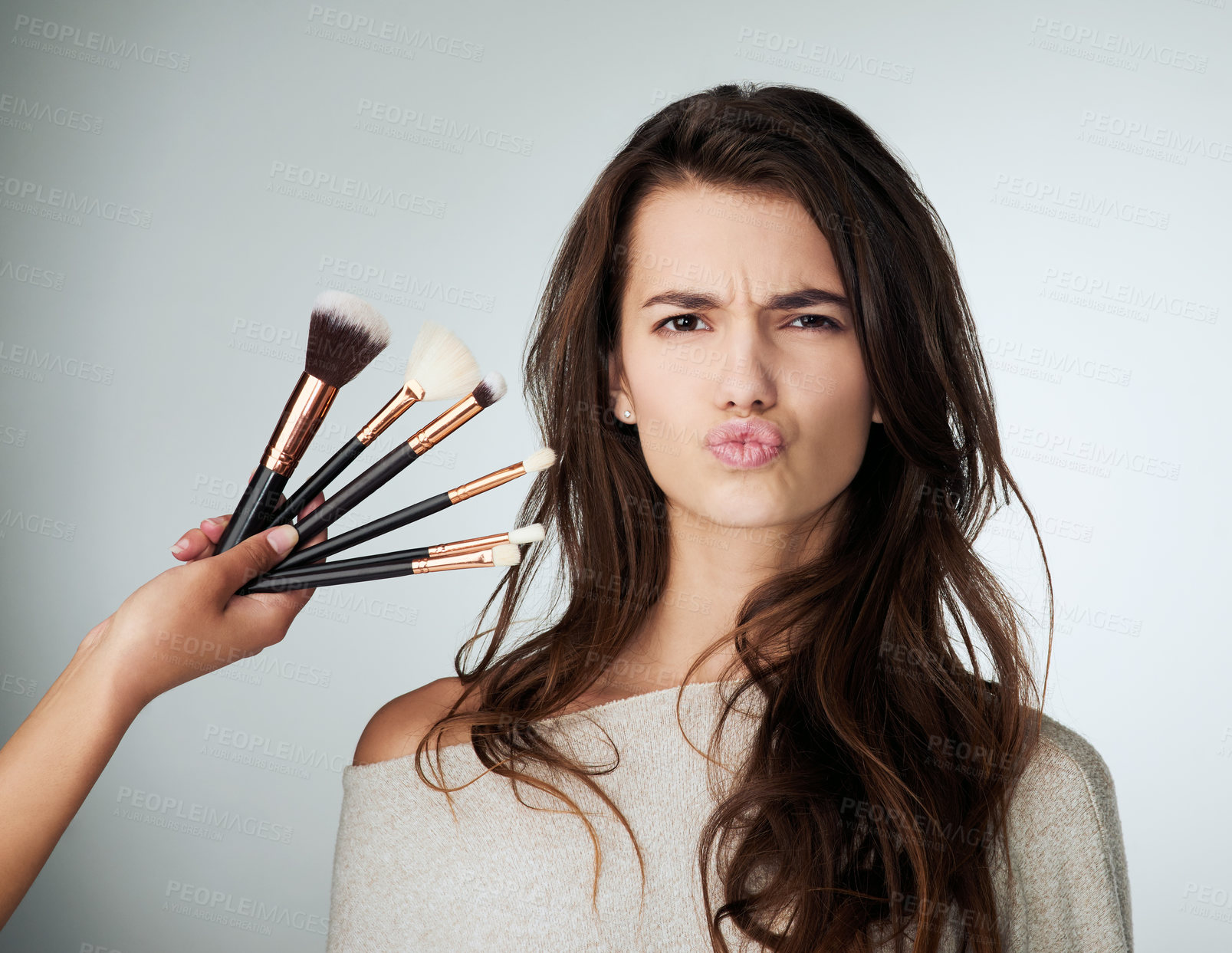 Buy stock photo Beauty, face and makeup brush for a woman in studio with a natural glow and lips. Portrait of a female person on a grey background for cosmetology transformation, cosmetic tools and facial skin care