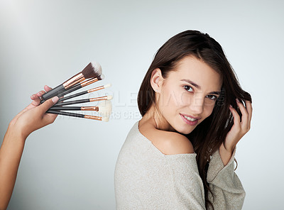 Buy stock photo Woman portrait, face and makeup brush for beauty in studio with a natural glow and shine. Headshot of a female person on a grey background with a hand for cosmetology, powder cosmetics and skin care
