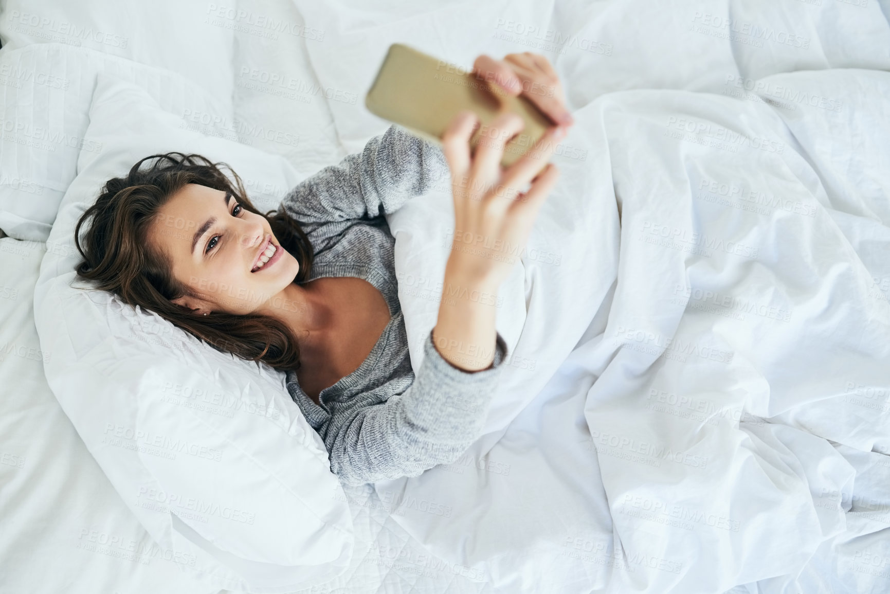 Buy stock photo Girl, happy or selfie in bed in morning for wake up vlog, live streaming or social media post in home. Influencer, smile or photography in bedroom for profile picture update, relax or rest in pyjamas