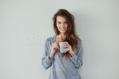 Buy stock photo Studio shot of an attractive young woman drinking coffee against a white background