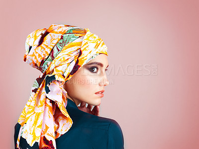 Buy stock photo Studio shot of a confident young woman wearing a colorful head scarf while posing against a pink background